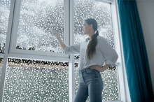 Load image into Gallery viewer, Lifestyle of a young lady in front of Etched floral window film