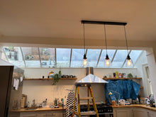 Load image into Gallery viewer, comparison of clear glass Velux windows and solar film installed on Velux with a slight blueish tint to reject heat in your kitchen 
