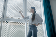 Load image into Gallery viewer, lifestyle of a young lady standing in front of  Etched shell window film