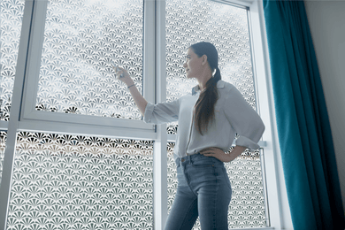 lifestyle of a young lady standing in front of  Etched shell window film