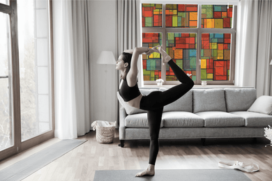 Lifestyle of a young lady doing a yoga pose in front of Fractal Cubic stained glass replication  window film