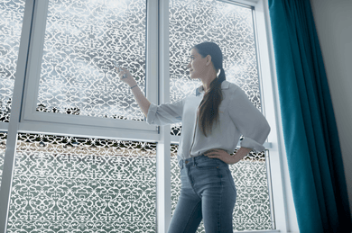 Lifestyle of a young lady in front of Etched Edwardian lace window film
