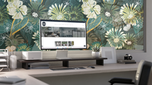 Load image into Gallery viewer, depiction of Green floral stained glass window film installed on large window in front of kwixstix.com website on home office computer